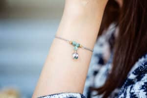 female wrist wearing tiny jewelry bracelet with mineral stone beads